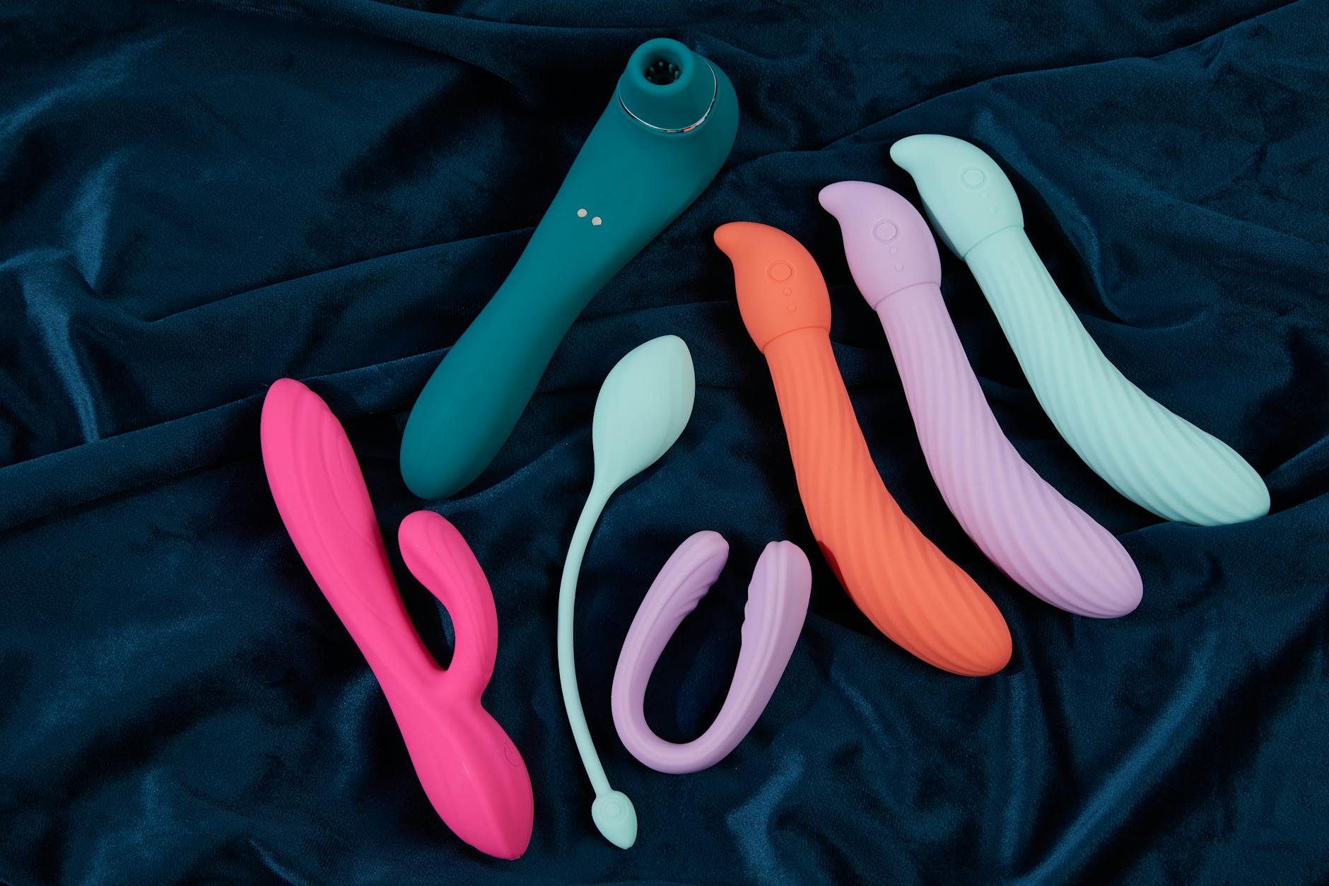 Couple holding a vibrator together, representing modern intimacy and connection across distance
