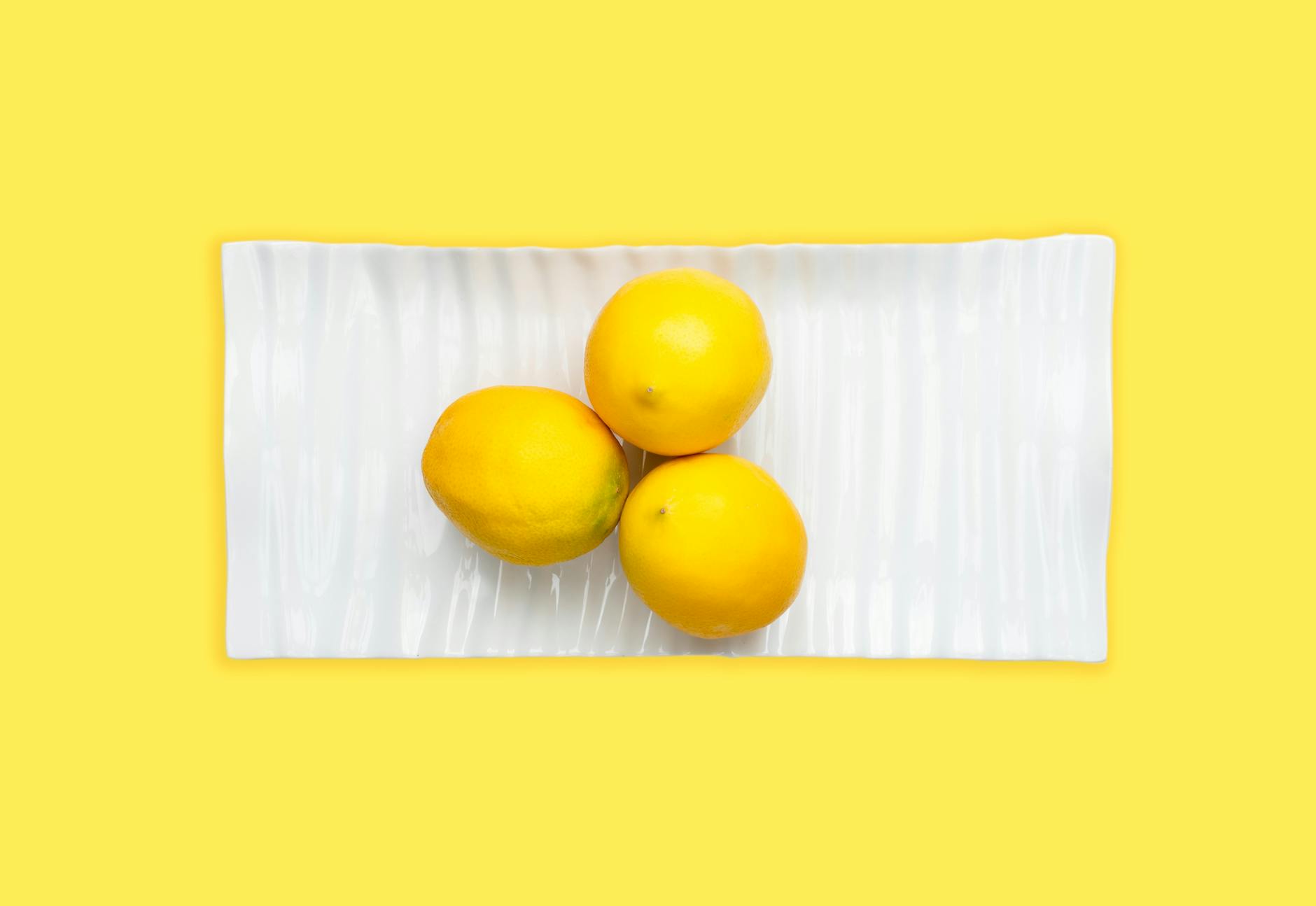 Colorful lemon vibrators and adult toys on bright yellow surface