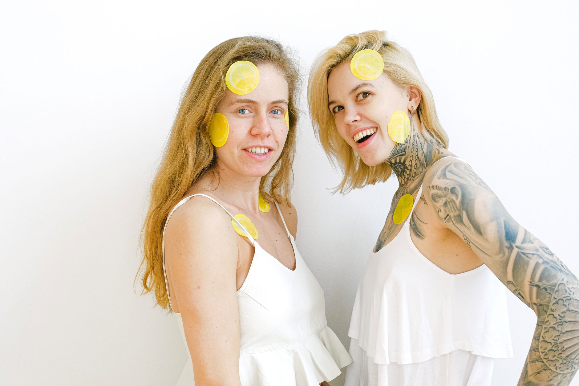 Two women laughing together, comfortable in their bodies and confident in their pleasure