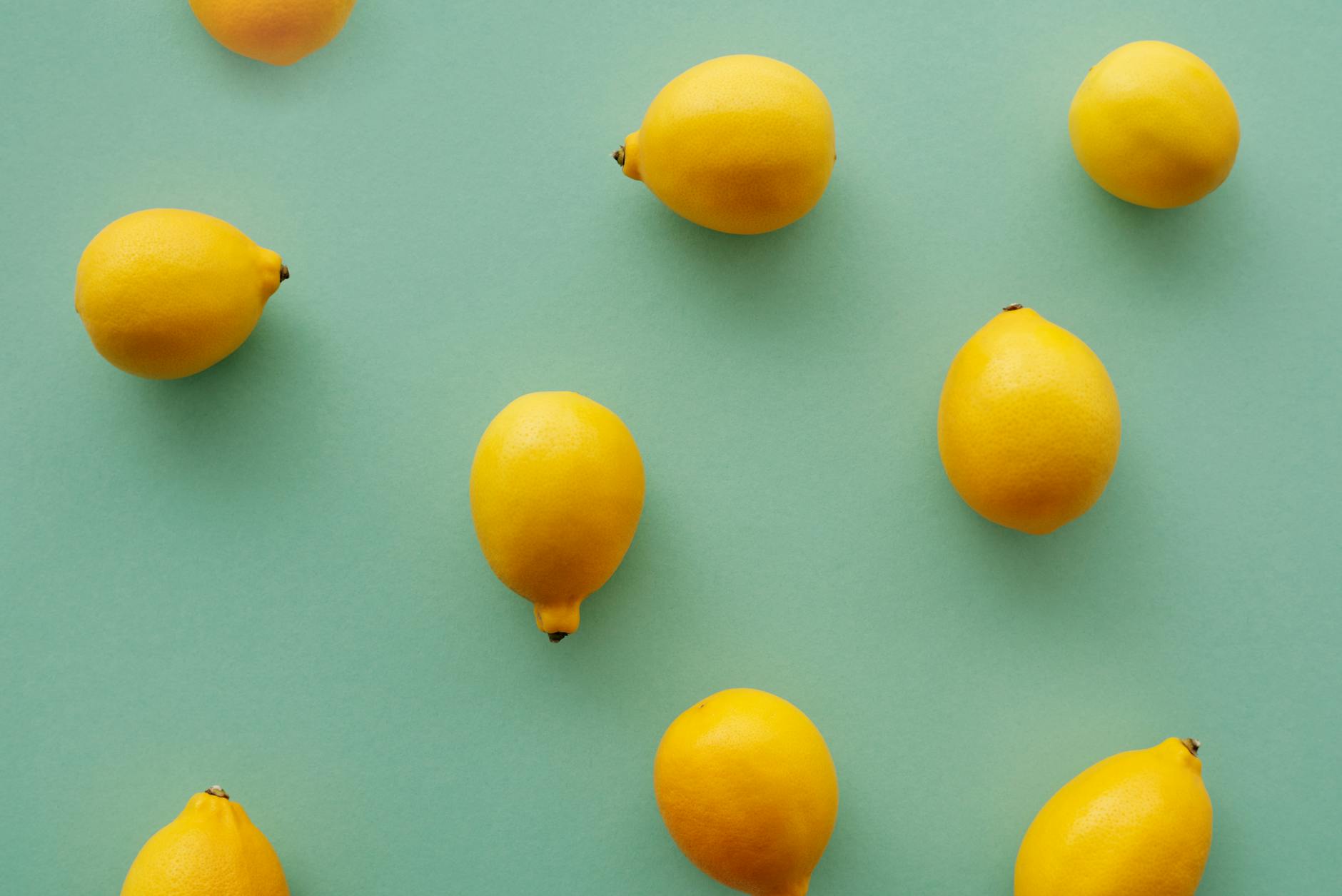 Bright yellow lemons on a green background, representing fresh approaches to pleasure